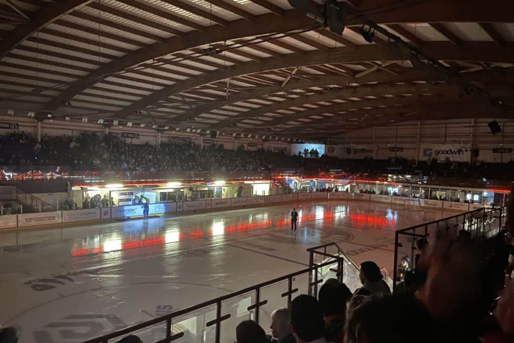 Bright orange lights shine down on altrincham ice rink also known as planet ice altrincham before a manchester storm ice hockey game in uk